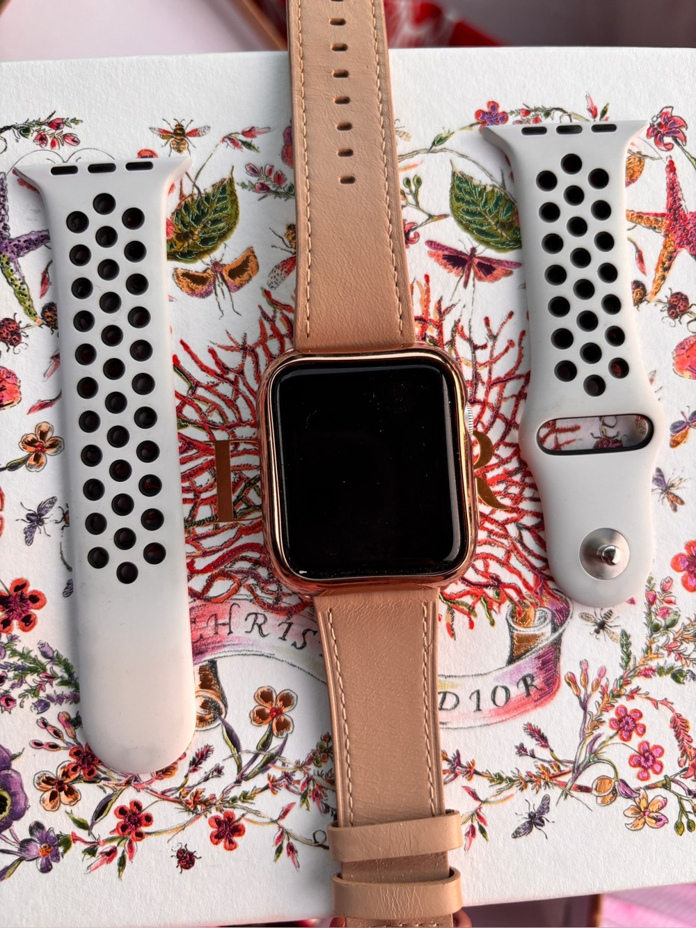 Apple Rose Gold Smartwatch with Beige Leather Band and White Sport Straps